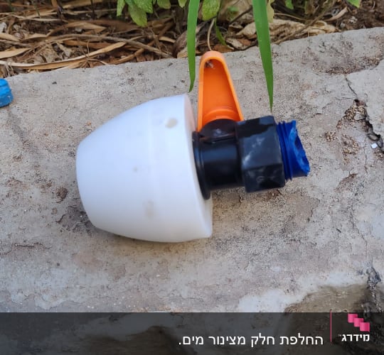 חלק פלסטיק לבן עם חיבורי צנרת על אבן